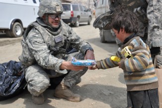 Soldier interacting with refugee child in Afghanistan